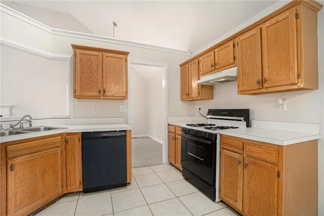 a kitchen with stainless steel appliances granite countertop a stove a sink dishwasher and a refrigerator