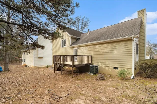 a view of a small house with a yard