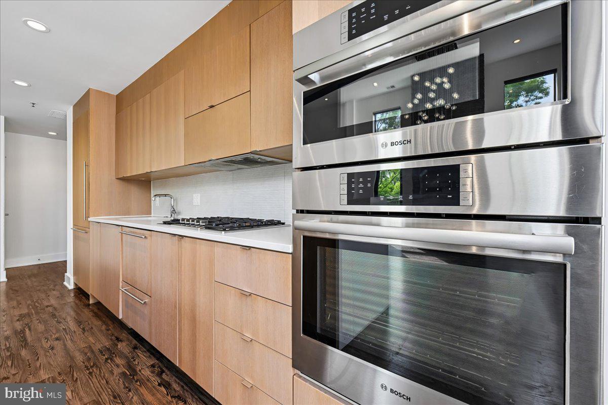 1111 W Street Northwest, Unit 12 Washington, DC 20009 - Photo 20 of 50 a kitchen with stainless steel appliances granite countertop a stove and a refrigerator