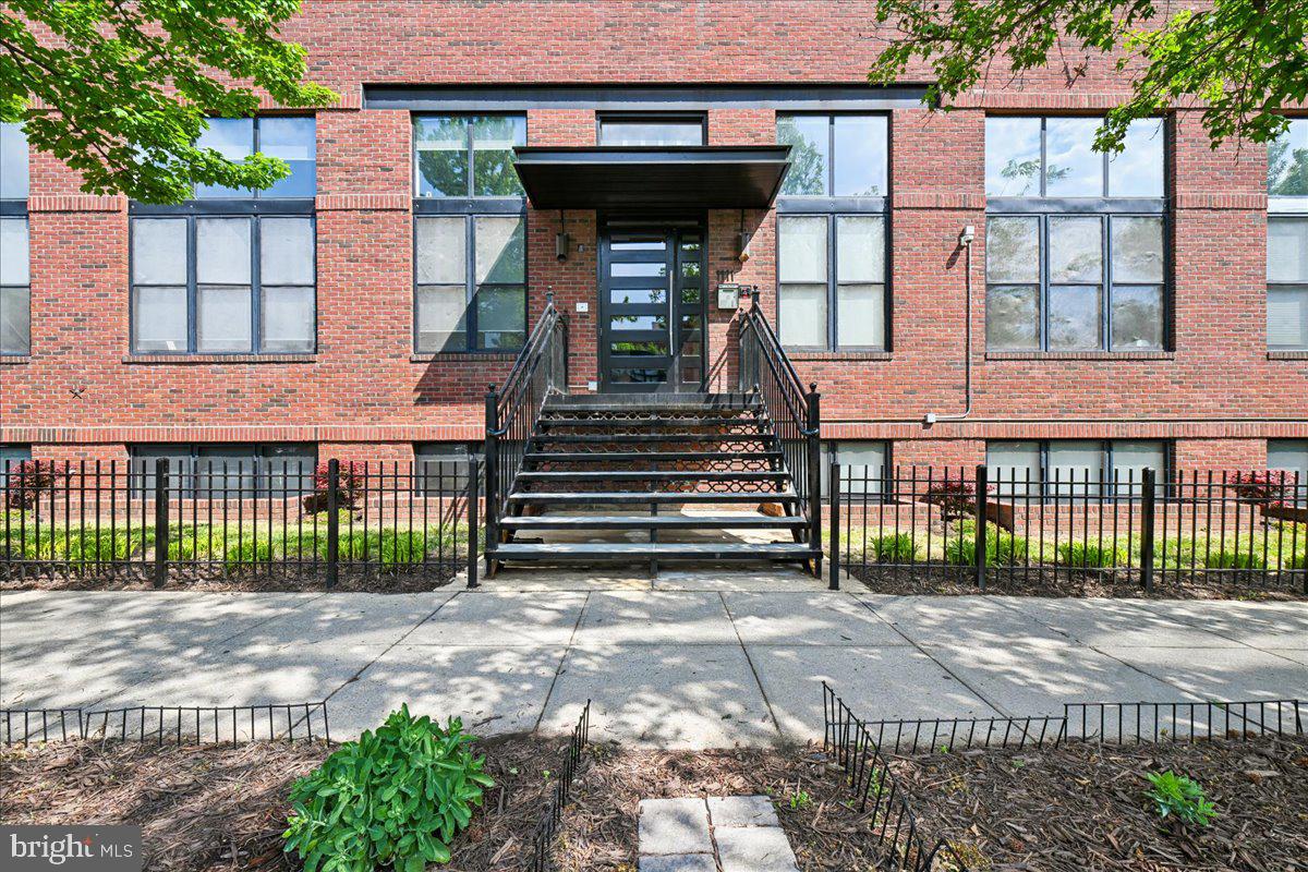 1111 W Street Northwest, Unit 12 Washington, DC 20009 - Photo 2 of 50 a view of a house with a small yard and a large tree
