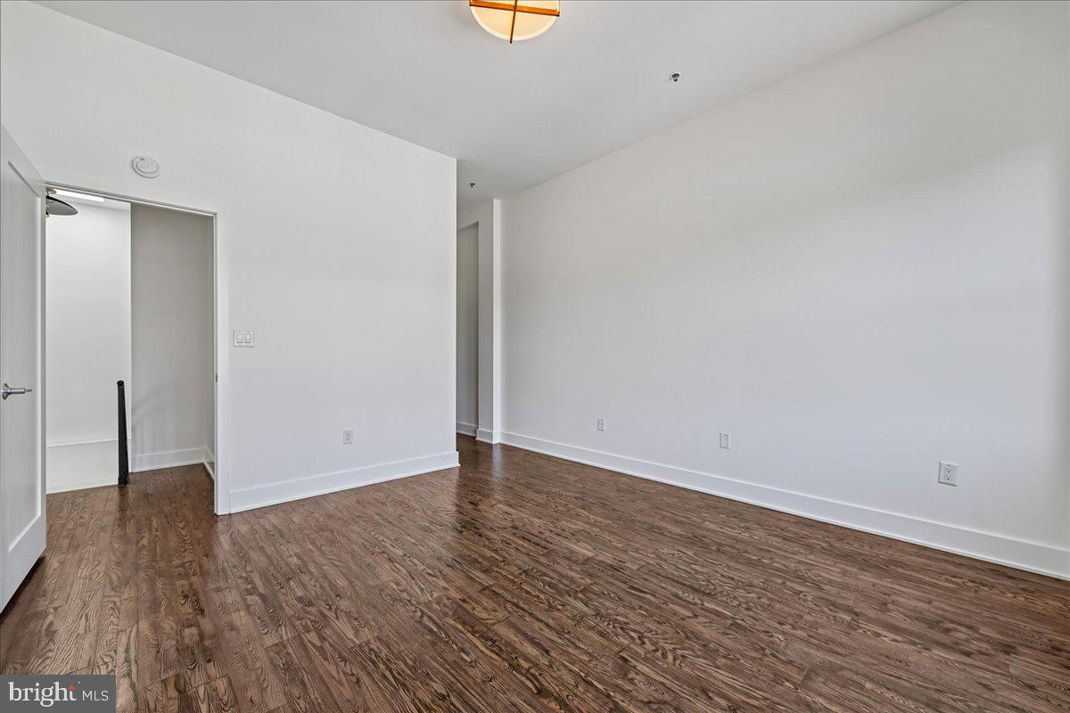 1111 W Street Northwest, Unit 12 Washington, DC 20009 - Photo 32 of 50 a view of an empty room with wooden floor and a window