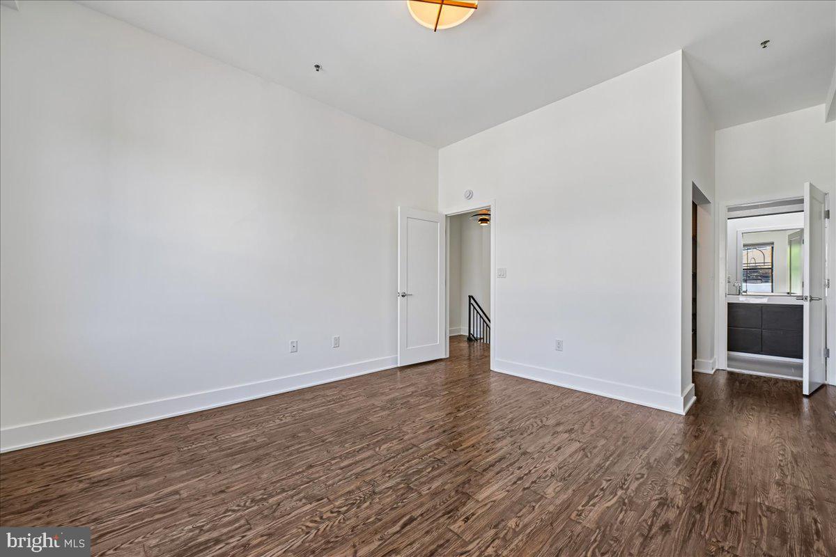 1111 W Street Northwest, Unit 12 Washington, DC 20009 - Photo 33 of 50 a view of an empty room with wooden floor and a window
