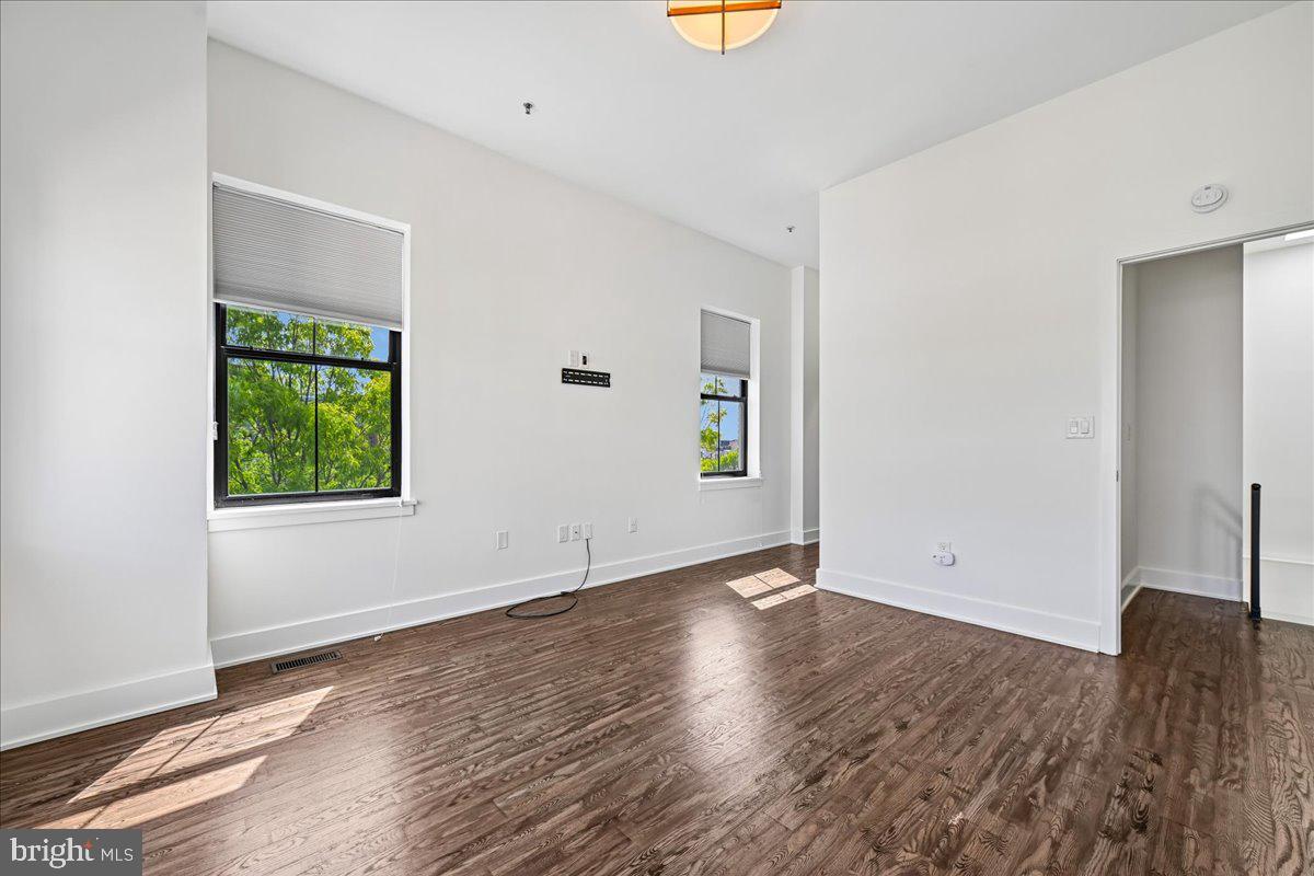 1111 W Street Northwest, Unit 12 Washington, DC 20009 - Photo 41 of 50 an empty room with window and wooden floor
