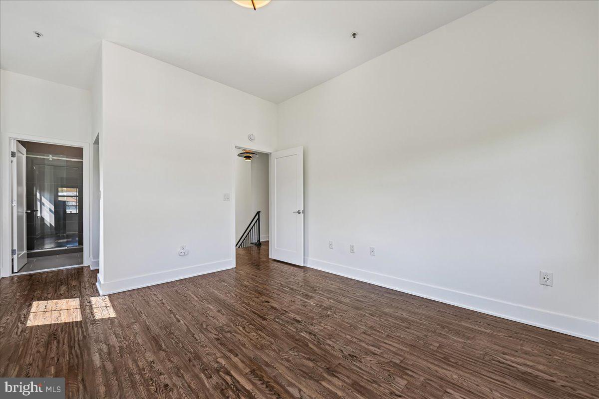 1111 W Street Northwest, Unit 12 Washington, DC 20009 - Photo 42 of 50 a view of an empty room and wooden floor
