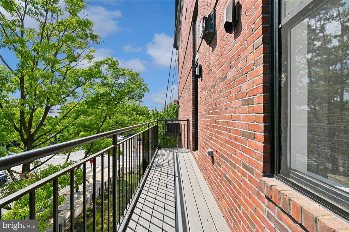 1111 W Street Northwest, Unit 12 Washington, DC 20009 - Photo 46 of 50 a view of a balcony with wooden floor