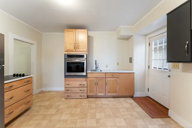 a view of kitchen with granite countertop cabinets and steel appliances