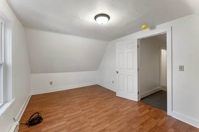 a view of empty room with windows and wardrobe