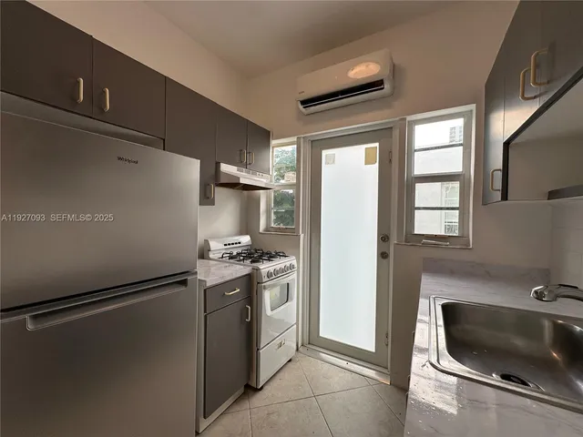 a kitchen with a refrigerator and a sink