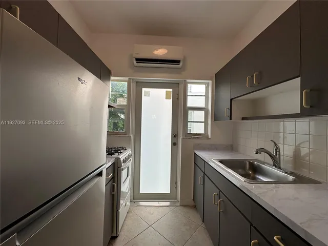 a kitchen with a sink and refrigerator