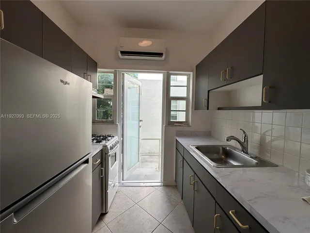 a kitchen that has a sink and a stove