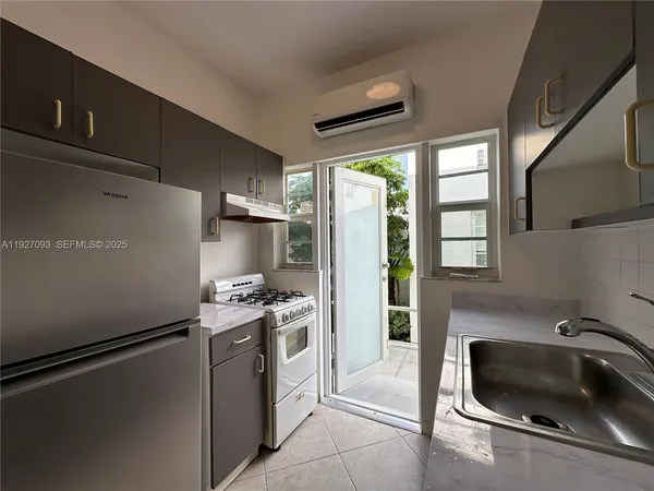 a kitchen with a refrigerator and a sink