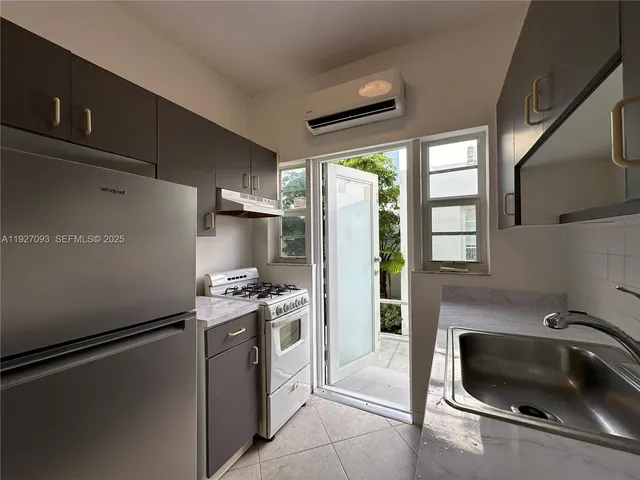 a kitchen with a refrigerator and a sink