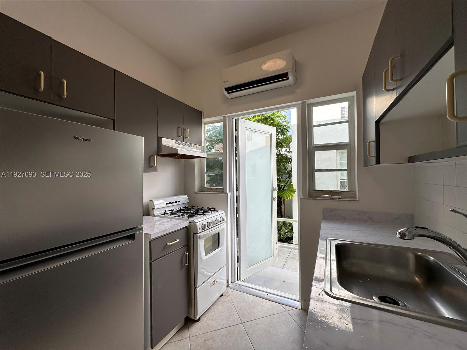 1540 Euclid Avenue, Unit 103 Miami Beach, FL 33139 - Photo 18 of 22 a kitchen with a refrigerator and a sink