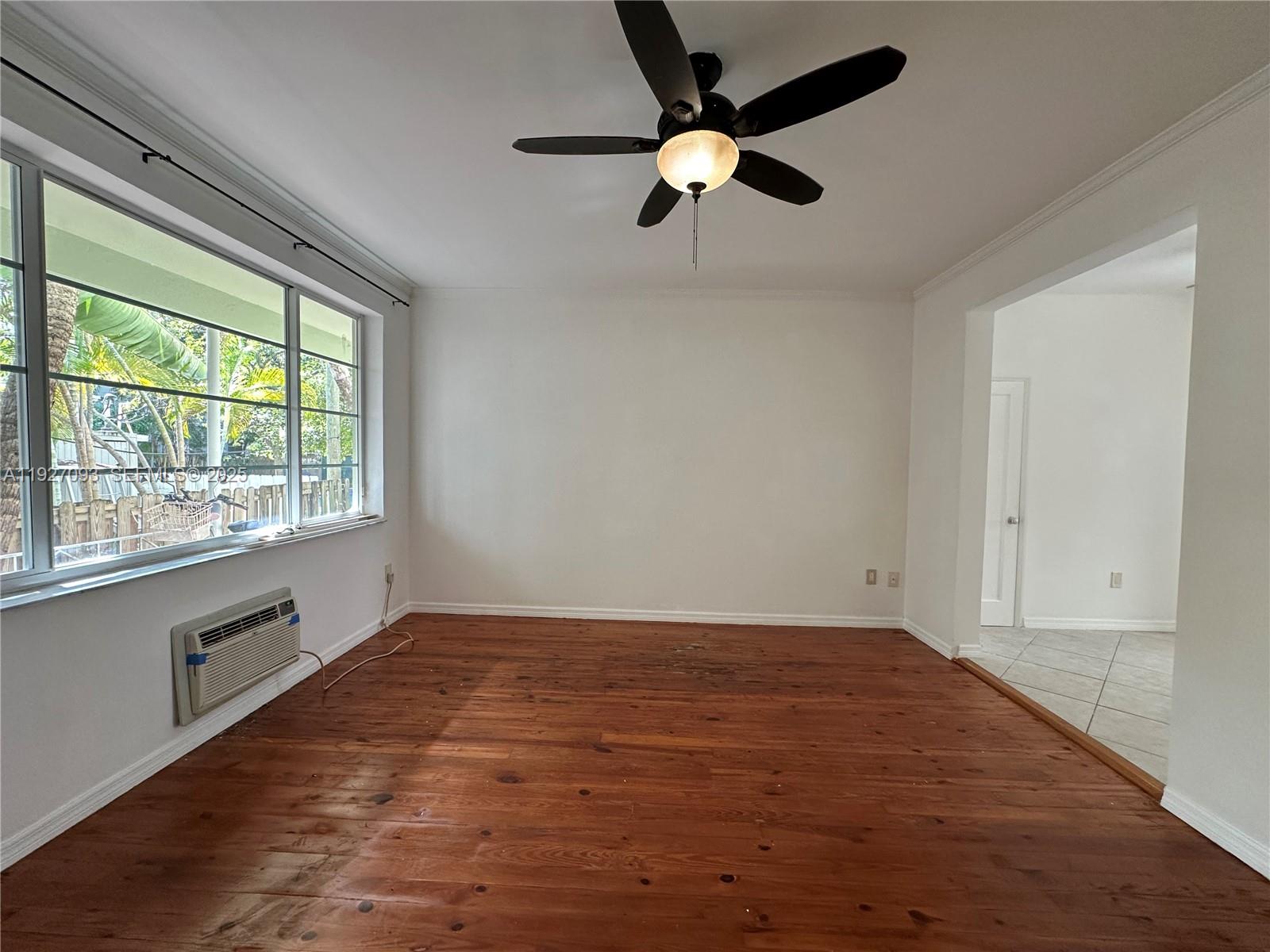 1540 Euclid Avenue, Unit 103 Miami Beach, FL 33139 - Photo 7 of 22 an empty room with a window and a fan