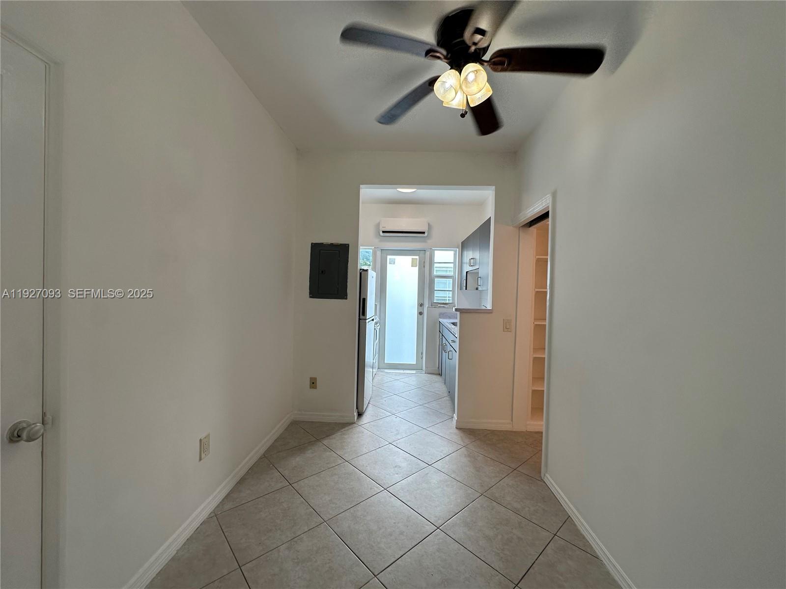 1540 Euclid Avenue, Unit 103 Miami Beach, FL 33139 - Photo 8 of 22 a view of a hallway with a chandelier fan and fire place