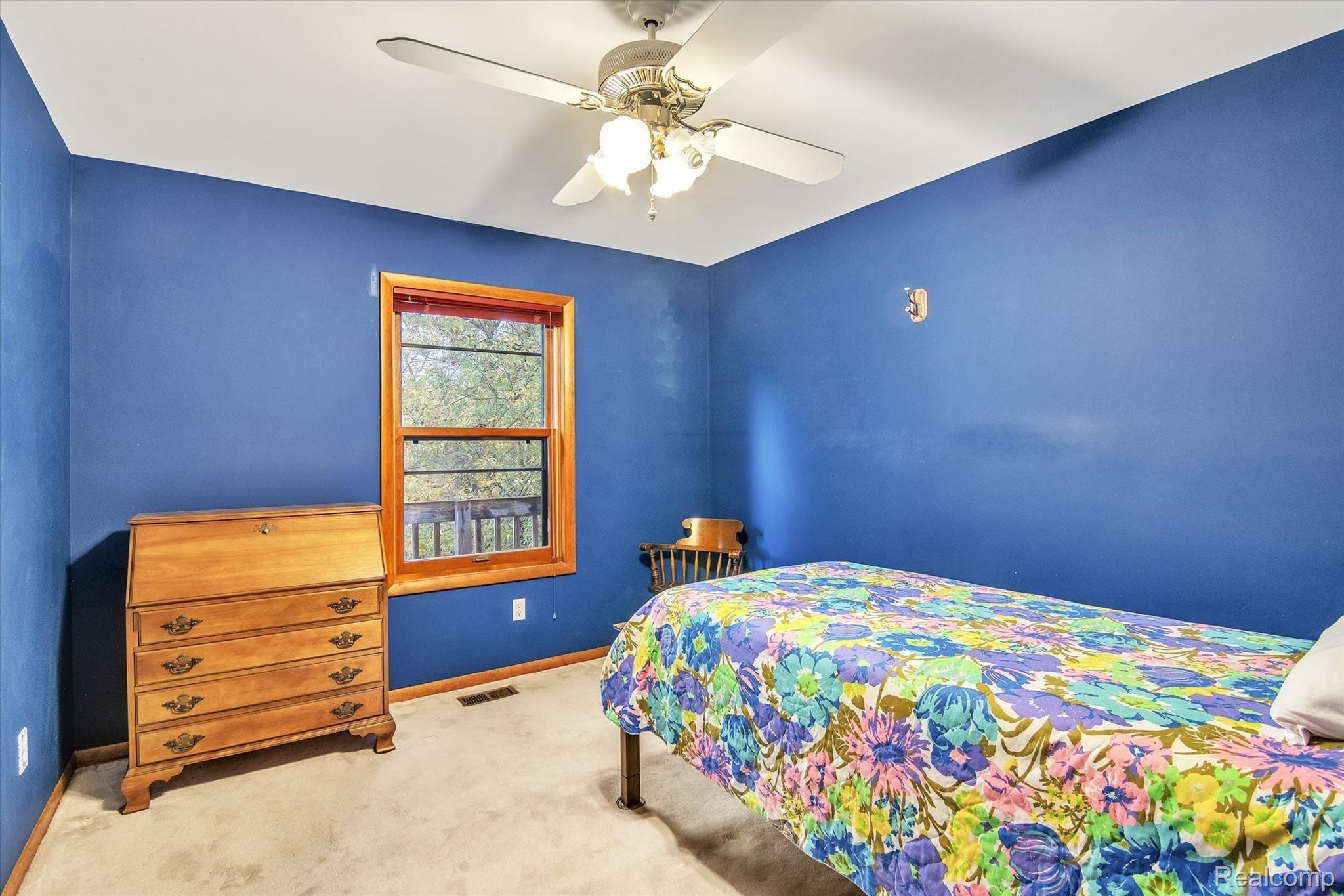 10419 Maple Road Hartland, MI 48353 - Photo 22 of 37 Primary bedroom with views of backyard with walk-in closet