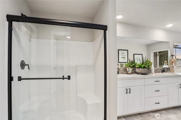 a bathroom with a double vanity sink toilet mirror and bathtub