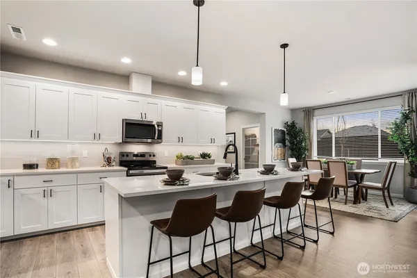 a kitchen with sink a stove and cabinets