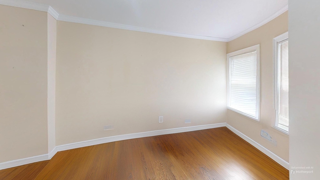 2973 Washington Street, Unit 3 Boston, MA 02119 - Photo 3 of 6 a view of an empty room with wooden floor and a window