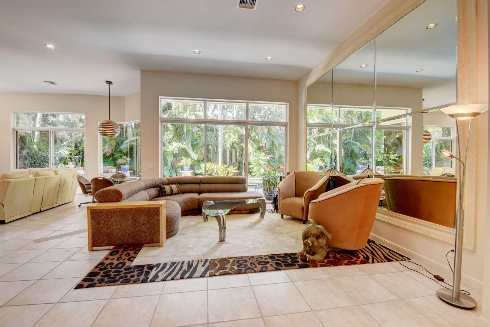 6053 Northwest 42nd Way Boca Raton, FL 33496 - Photo 7 of 23 a living room with furniture and a floor to ceiling window