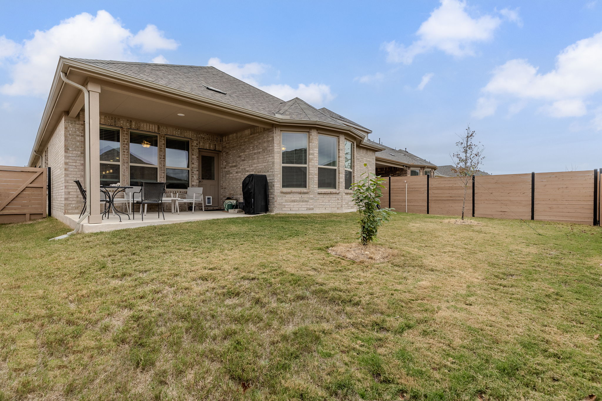 116 Raleigh Drive Georgetown, TX 78633 - Photo 25 of 28 A spacious backyard provides ample room for outdoor activities, complementing a covered patio perfect for relaxation.