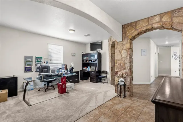 a view of a livingroom with workspace and a window
