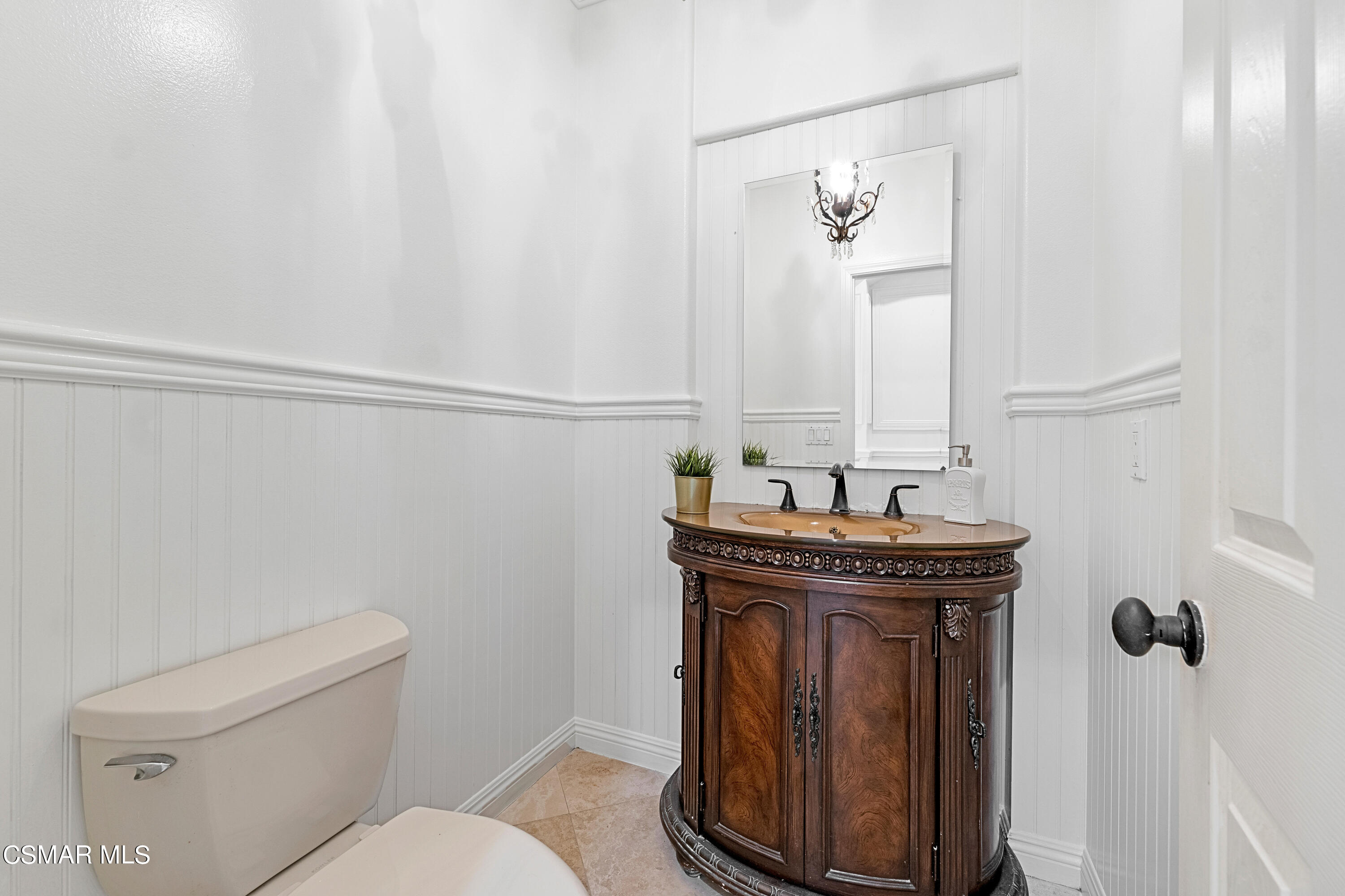 6196 Deerhill Road Oak Park, CA 91377 - Photo 12 of 46 a bathroom with a toilet a sink and mirror