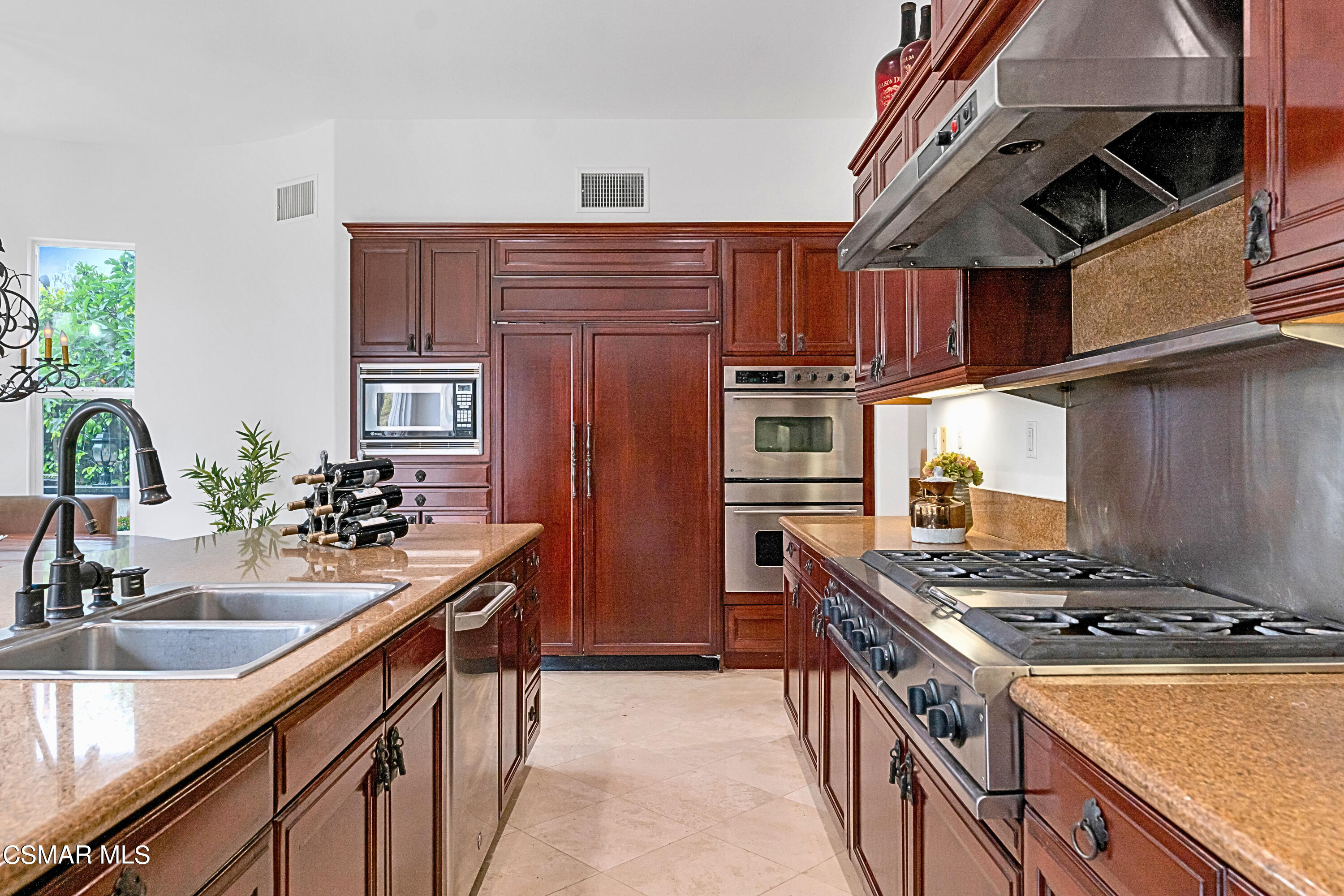 6196 Deerhill Road Oak Park, CA 91377 - Photo 19 of 46 a kitchen with stainless steel appliances granite countertop a sink stove and refrigerator