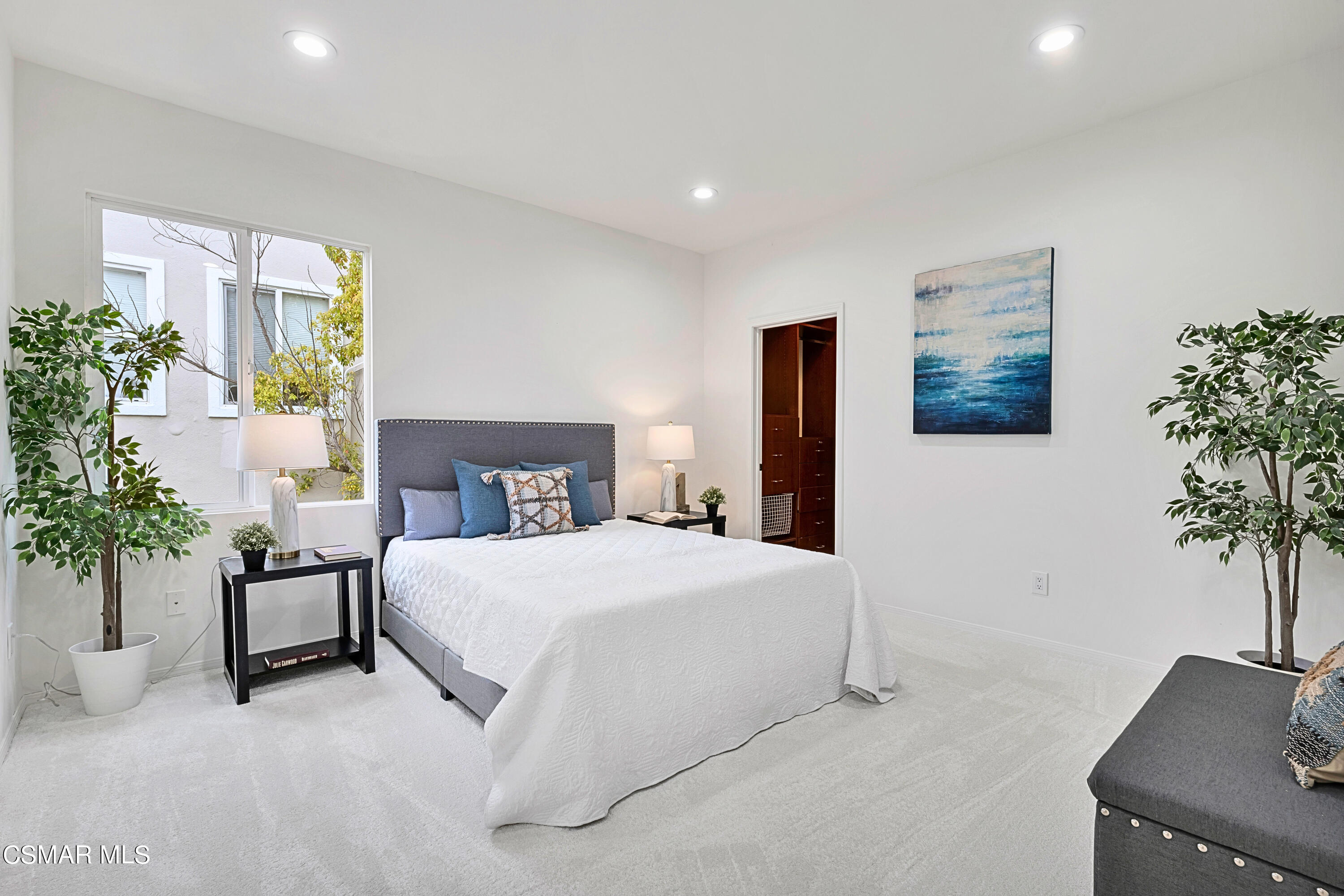 6196 Deerhill Road Oak Park, CA 91377 - Photo 25 of 46 a spacious bedroom with a bed and a potted plant