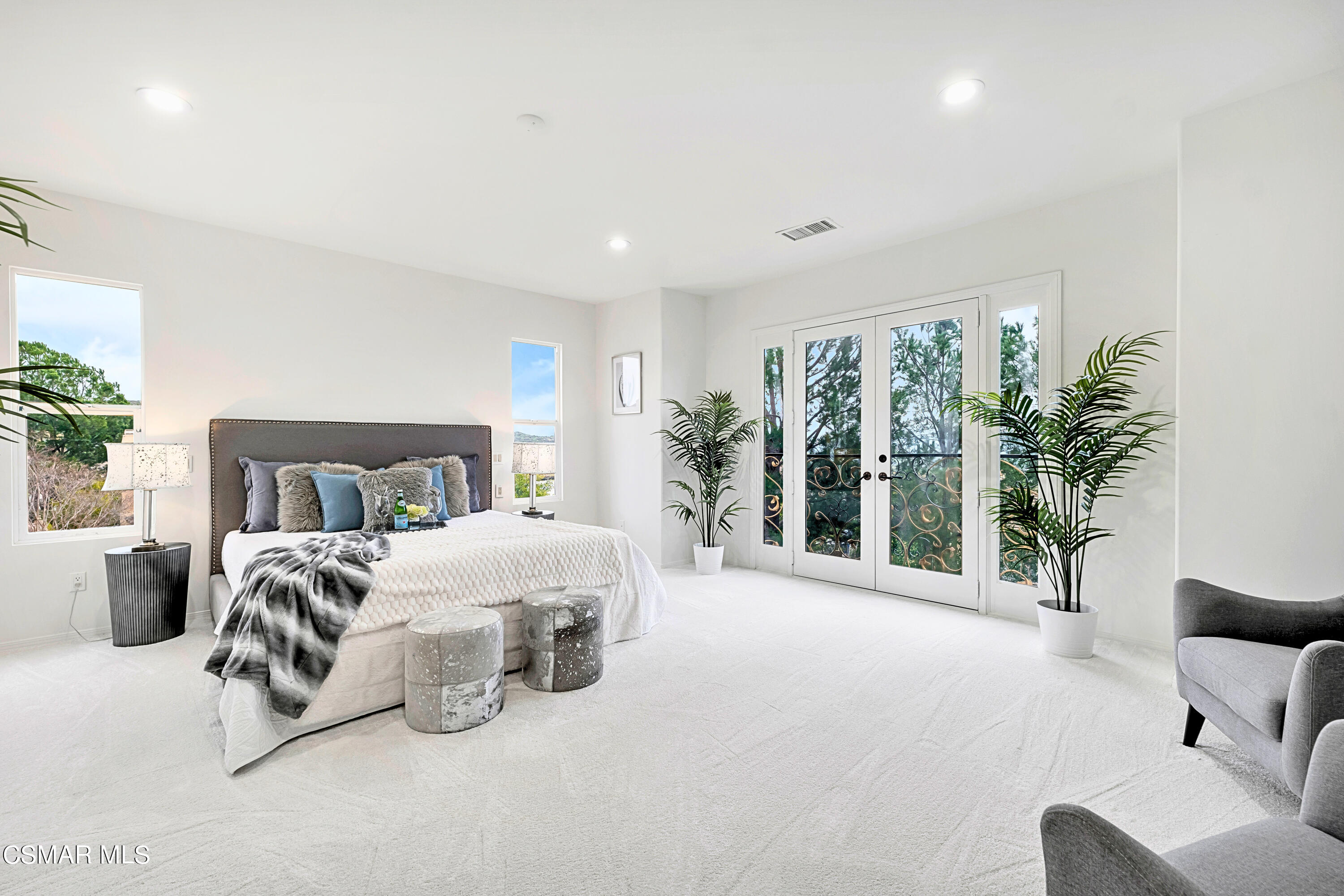 6196 Deerhill Road Oak Park, CA 91377 - Photo 32 of 46 a spacious bedroom with a bed and a large window