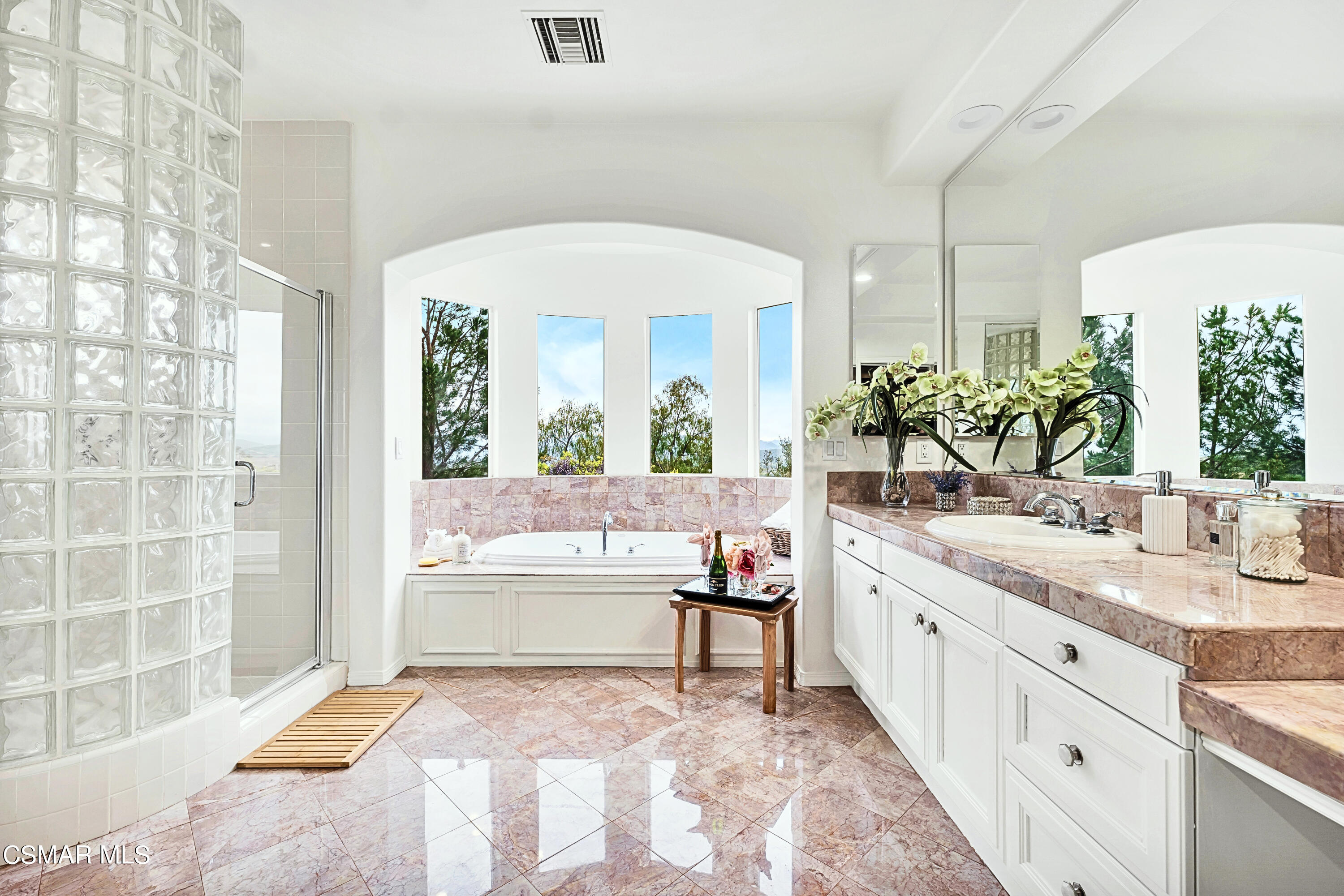6196 Deerhill Road Oak Park, CA 91377 - Photo 36 of 46 a spacious bathroom with a granite countertop tub a sink and a large mirror