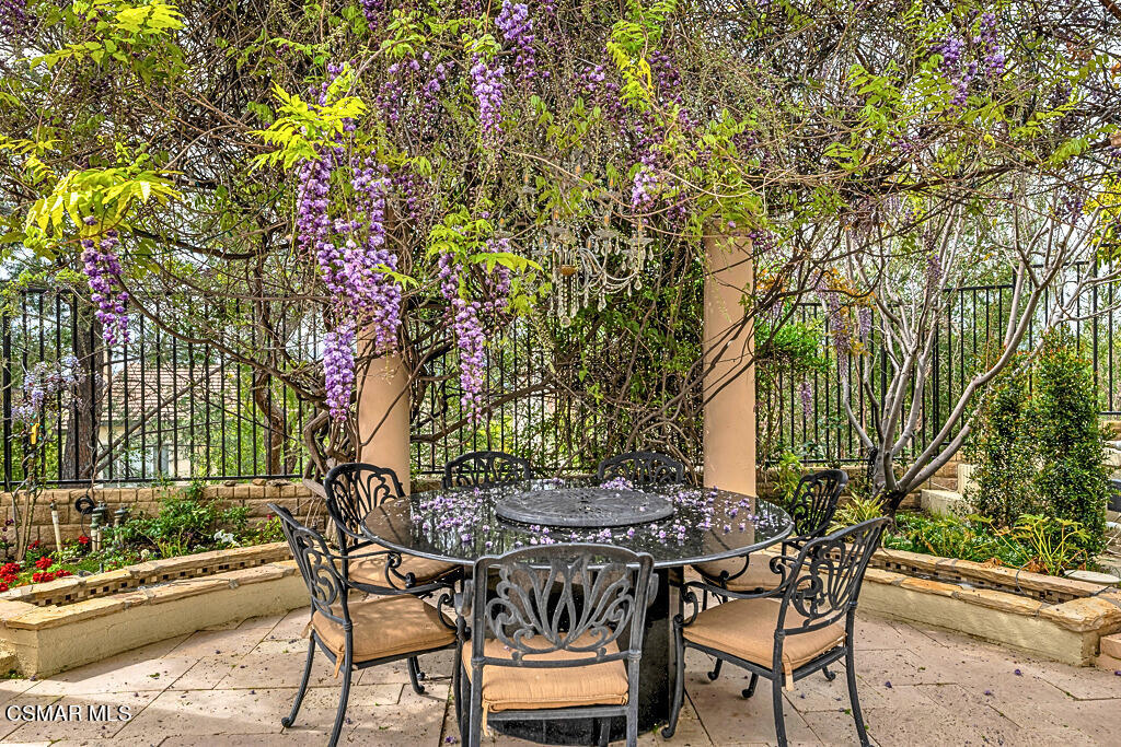 6196 Deerhill Road Oak Park, CA 91377 - Photo 37 of 46 a view of a backyard with table and chairs and potted plants