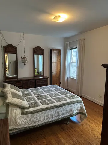 a bedroom with a bed and a dresser