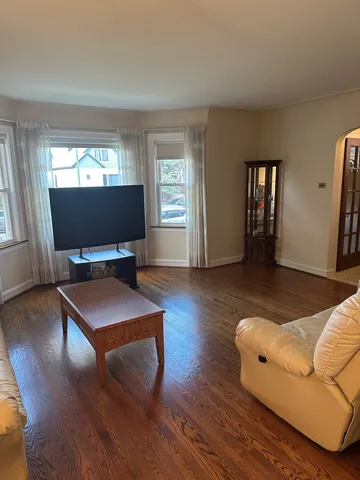 a living room with furniture window and wooden floor