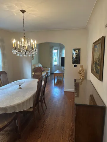 a view of a dining room with furniture and chandelier