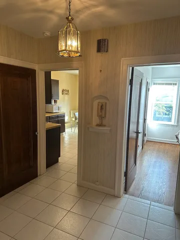 a view of a refrigerator in kitchen and a window