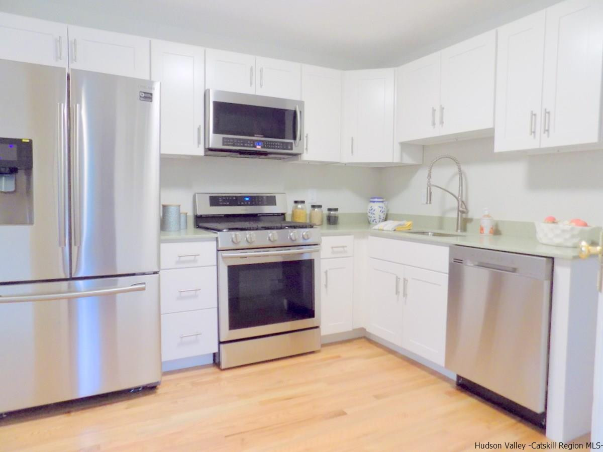 4494 Atwood Road Stone Ridge, NY 12484 - Photo 5 of 33 a kitchen with stainless steel appliances granite countertop a refrigerator stove a sink and a microwave