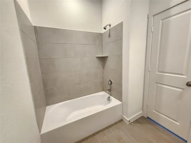 a bathroom with a bathtub and shower