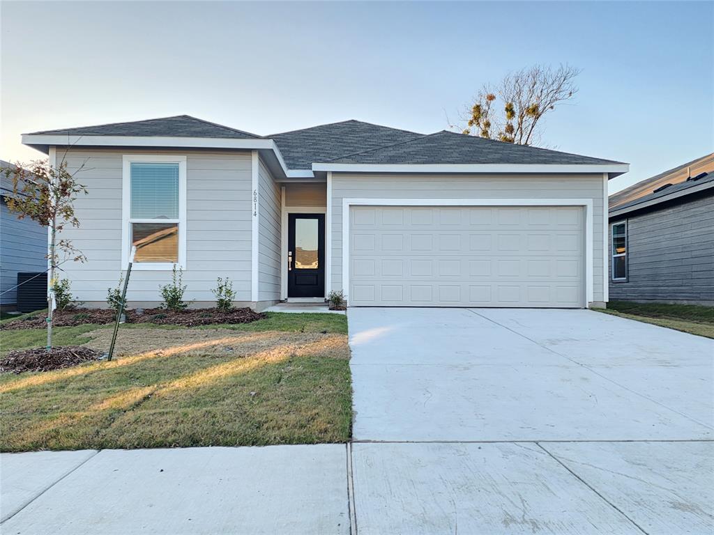 6814 Welsh Drive Princeton, TX 75407 - Photo 16 of 16 a front view of a house with a yard and garage