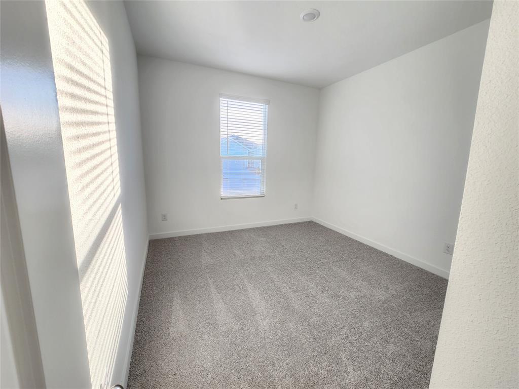 6814 Welsh Drive Princeton, TX 75407 - Photo 6 of 16 an empty room with windows