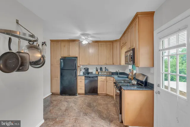 a kitchen with a refrigerator and a stove top oven