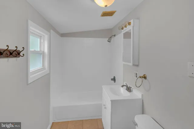 a bathroom with a shower a toilet and sink