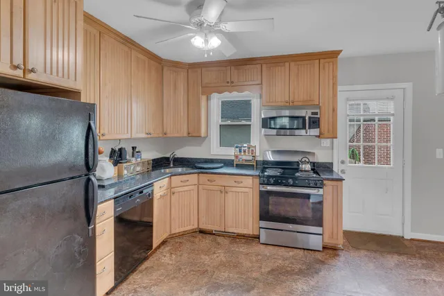a kitchen with stainless steel appliances granite countertop a stove top oven a sink and dishwasher
