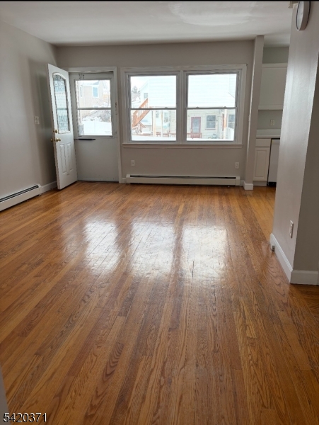 35 Carey Avenue, Unit 19 Butler, NJ 07405 - Photo 2 of 8 an empty room with wooden floor and windows