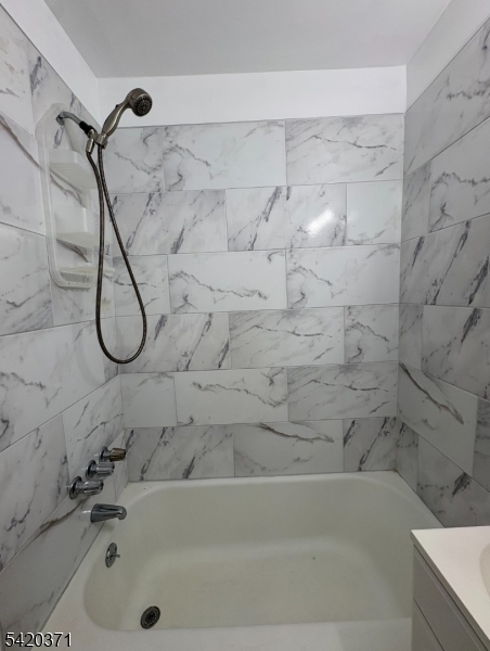 35 Carey Avenue, Unit 19 Butler, NJ 07405 - Photo 4 of 8 a bathroom with a bath tub and a shower