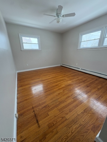 35 Carey Avenue, Unit 19 Butler, NJ 07405 - Photo 5 of 8 a view of empty room with wooden floor