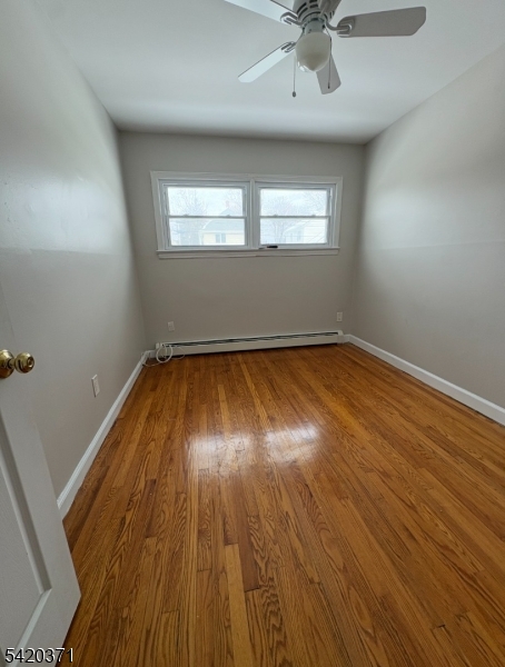 35 Carey Avenue, Unit 19 Butler, NJ 07405 - Photo 6 of 8 wooden floor in an empty room with a window