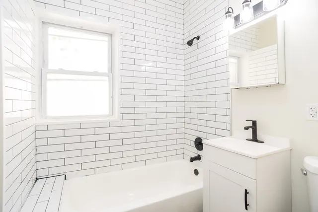 a bathroom with a bathtub and shower