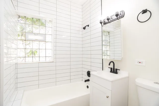 a bathroom with a bathtub a sink and a shower