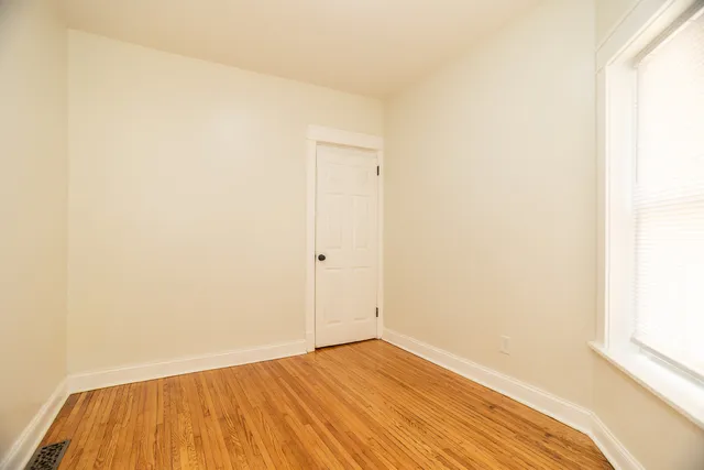a view of a room with wooden floor and white wall